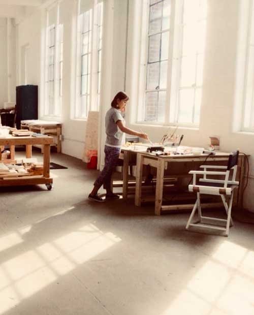 Chizu Omori working on encaustic art in studio